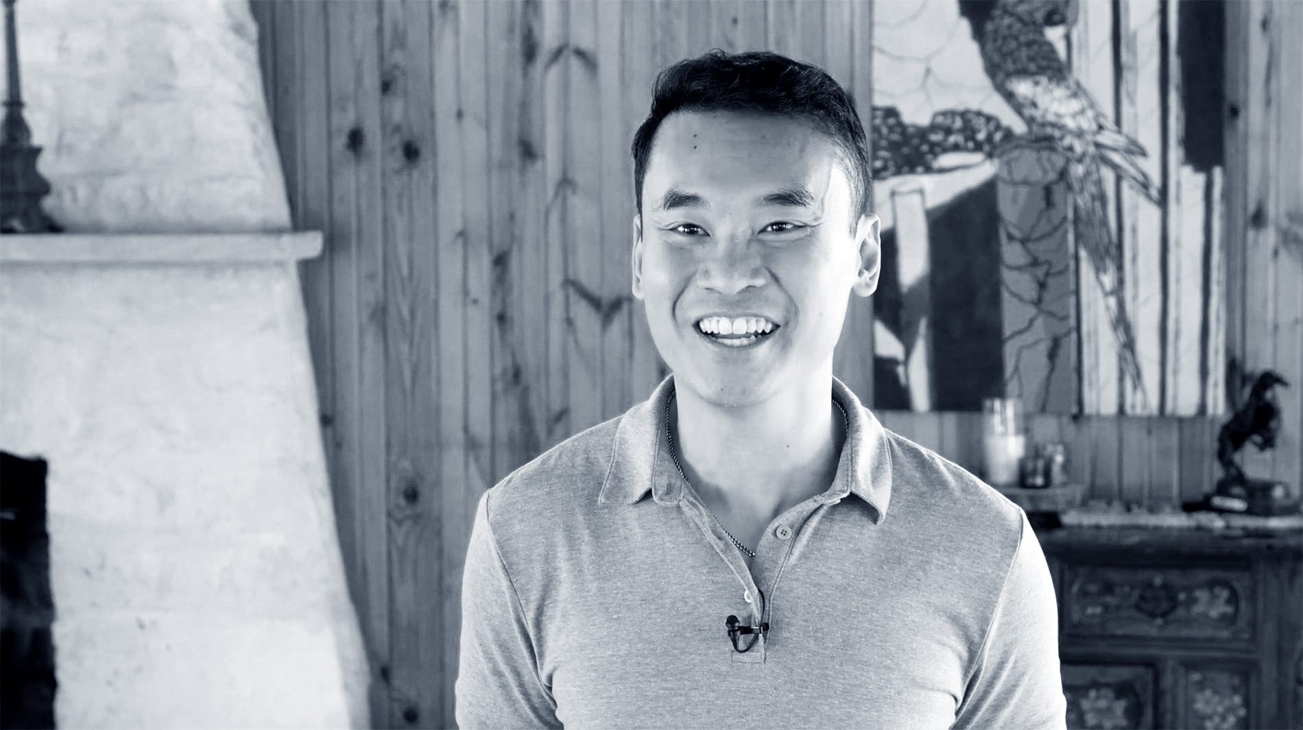 black and white photo of a smiling man