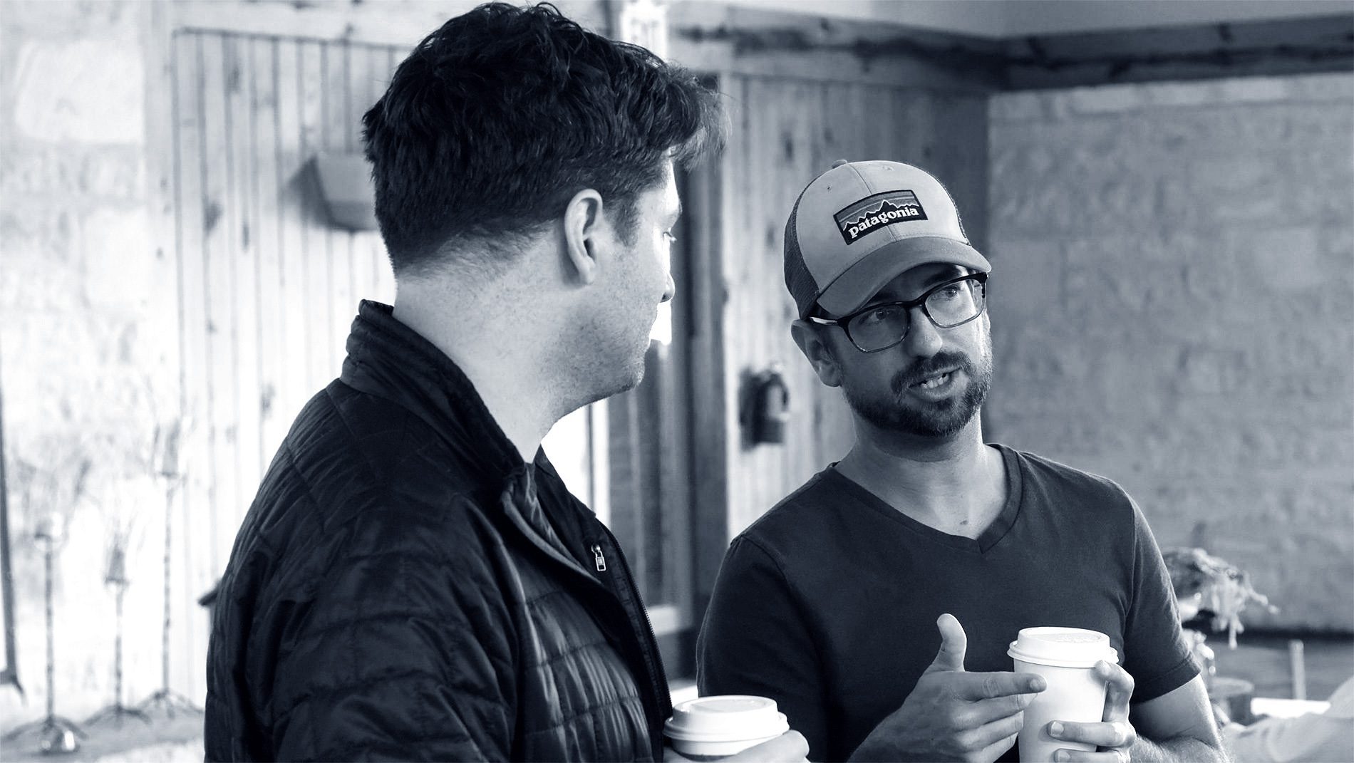 black and white photo of two men talking